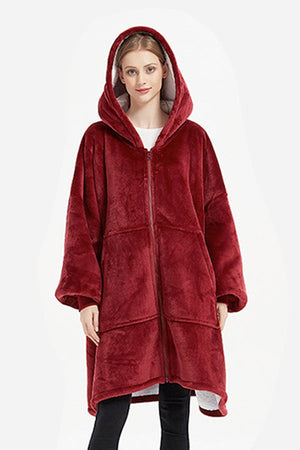 Oversized ultra soft hooded blanket in deep red with zipper and large front pockets, cozy and warm flannel sherpa material.