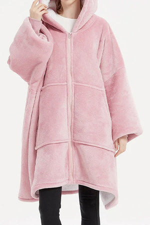 Pink oversized ultra soft hooded blanket with zipper and large front pockets for warmth.