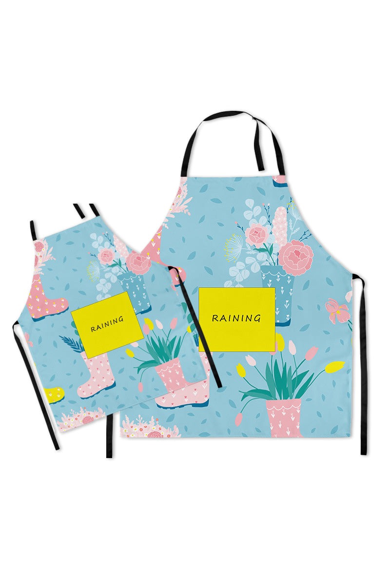 Mommy & Me Apron Set with matching blue floral and pink rain boots pattern, durable cotton linen, oil-proof coating, and convenient pockets for parent and child cooking together