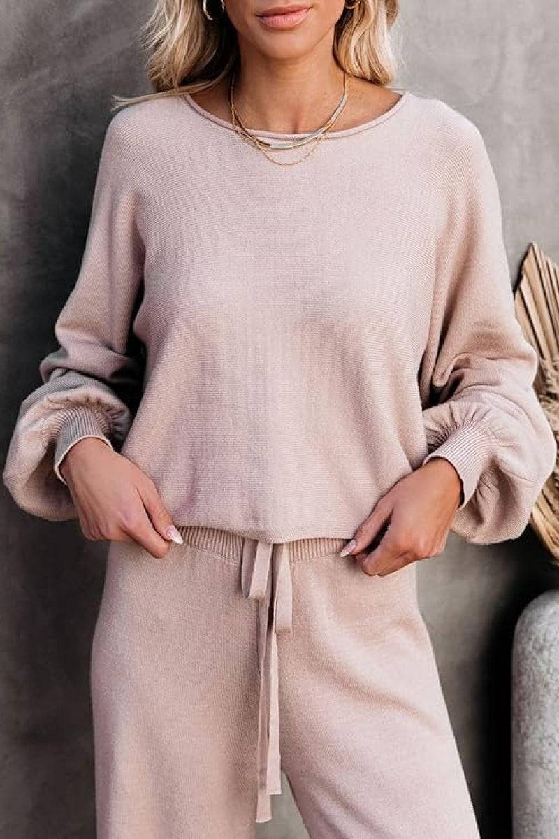 Woman wearing beige round neck loose fit cozy two-piece set with long sleeves and drawstring pants