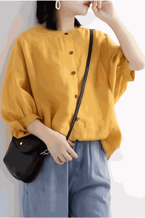 Relaxed loose breathable linen blouse in vibrant yellow with button-down front and puff sleeves, styled with casual blue pants and black shoulder bag.