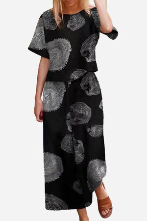 Loose Fit Co-ord Set with black wide-leg trousers and short-sleeve top featuring abstract circular patterns.