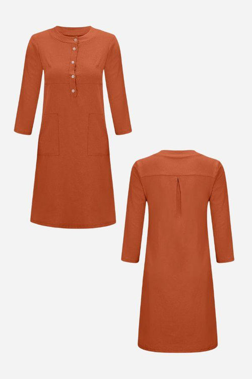 Rust-colored cotton dress with ¾ sleeves, button front, and pockets shown from front and back.