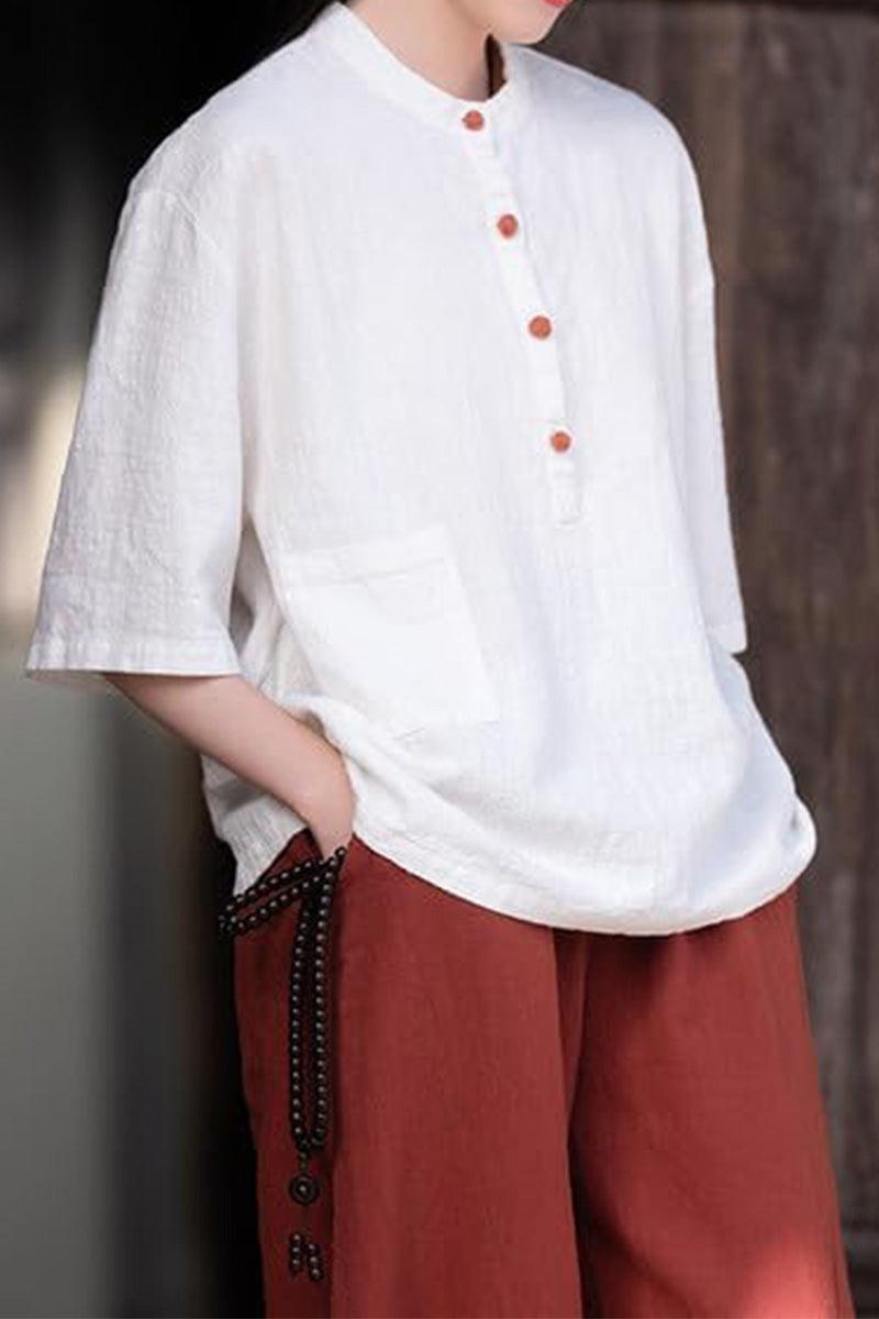 White ramie linen and cotton blend shirt with half sleeves and front buttons, paired with rust-colored pants.