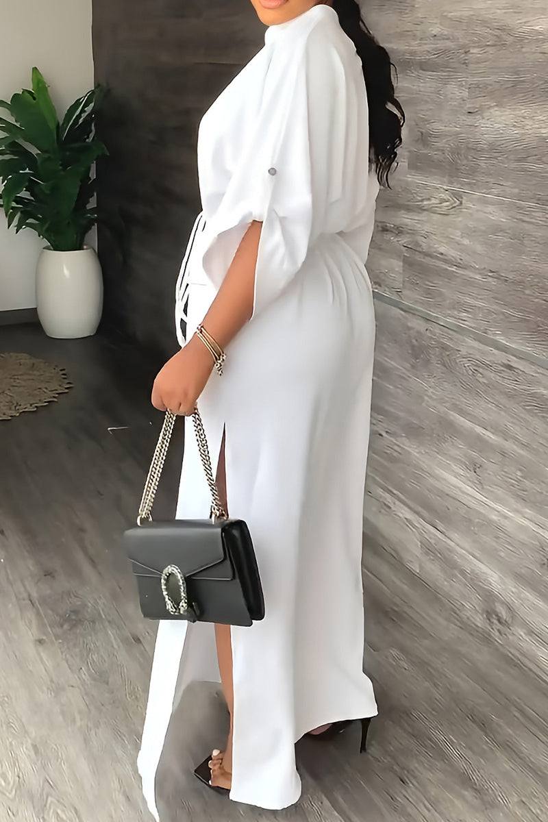 White All-Day Drape Dress with adjustable waist tie and front slit, styled with a black handbag and heels.