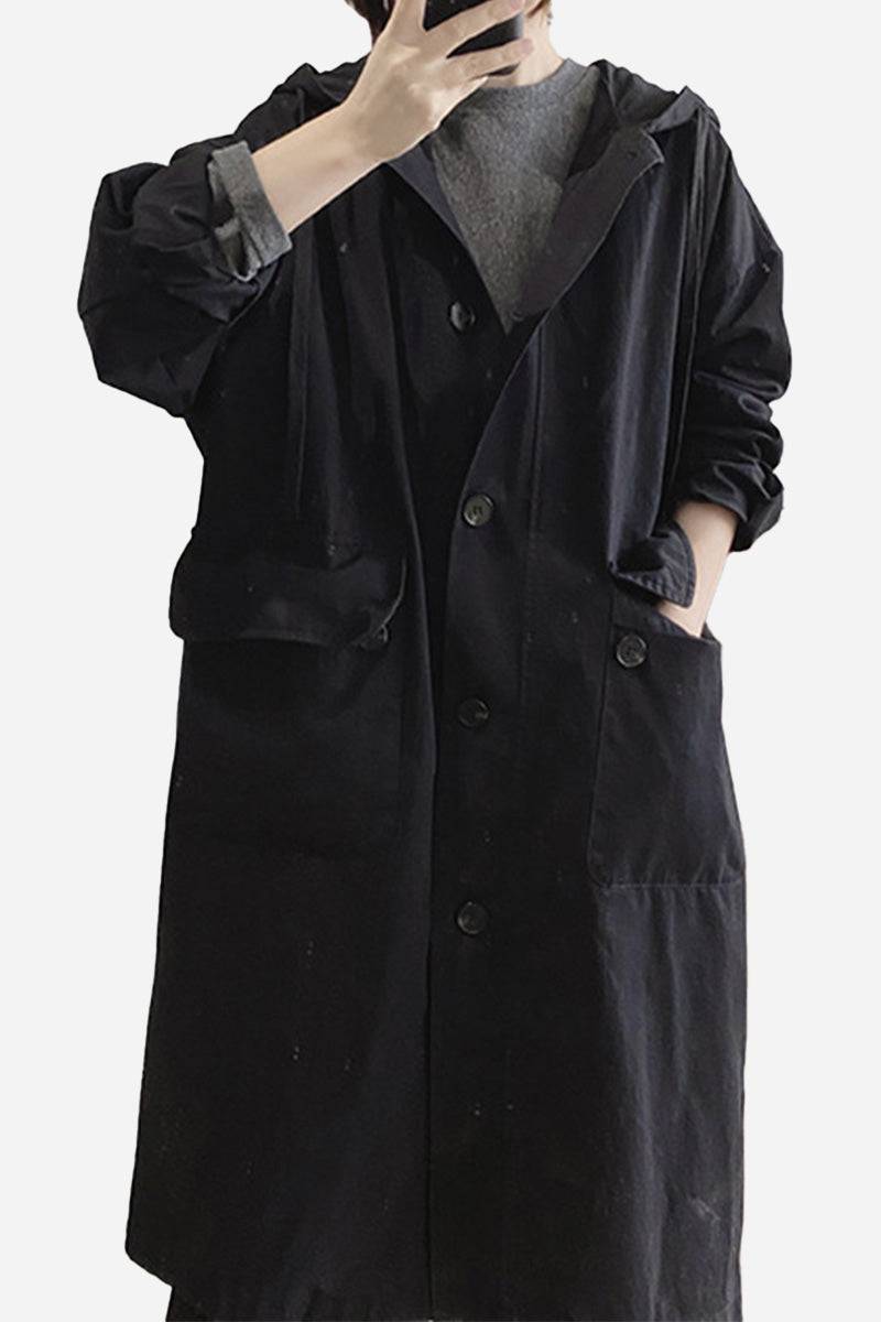 Black travel-ready hooded windbreaker with snap buttons and pockets, made of breathable 100% cotton, one size fits all.