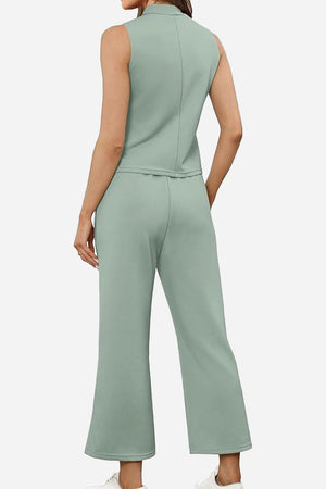 Back view of model wearing Cotton Chic Sleeveless two-piece set in light green with sleeveless top and wide-leg pants