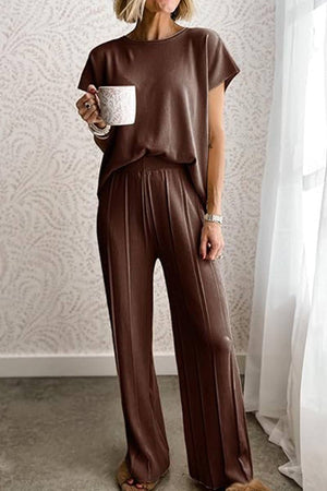 First Class Travel two-piece brown pleated loungewear set with wide-leg pants and short sleeve top for comfortable, wrinkle-resistant travel style