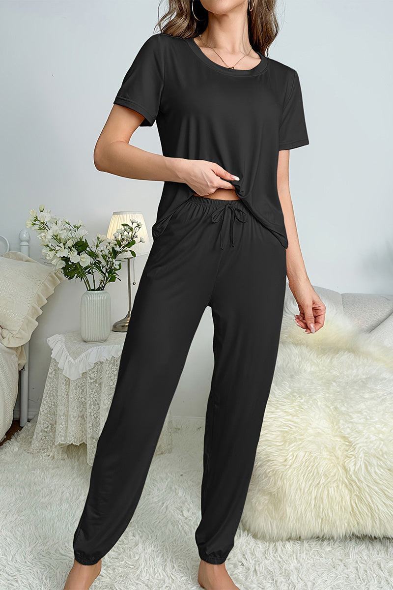 Woman wearing black My Go To Loungewear soft breathable two-piece set in cozy home setting