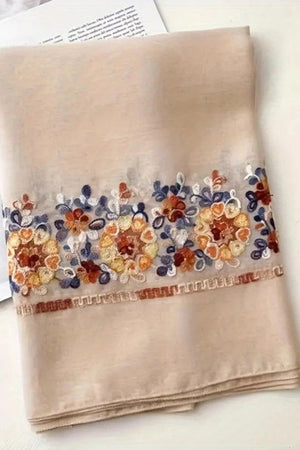 Beige embroidered travel-must shawl with floral detailing, lightweight and versatile wrap for travel and sun protection
