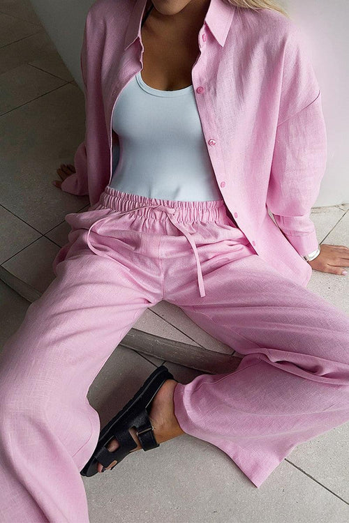 100 Cotton Wanderlust pink two-piece cotton set with relaxed fit and button-up shirt worn with white tank top and black sandals