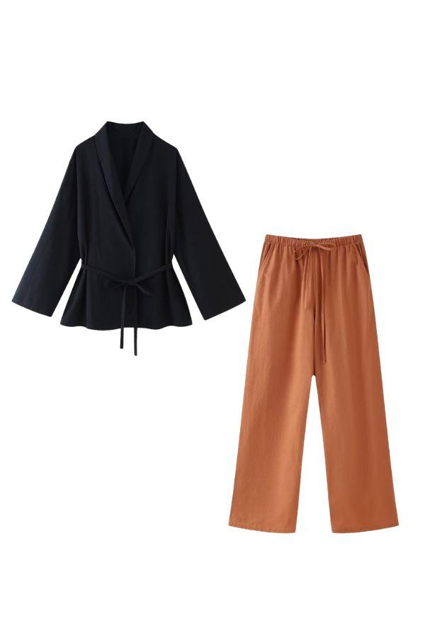 Mix-match lounge-to-travel set with black wrap top and rust wide-leg pants, comfortable and stylish for versatile wear.
