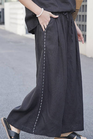 Black 100% linen wide-leg pants with elastic waist and side seam detail