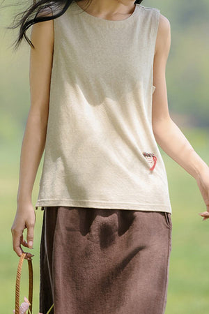 Woman wearing Dandelion Fields Cotton Linen sleeveless top with embroidered detail