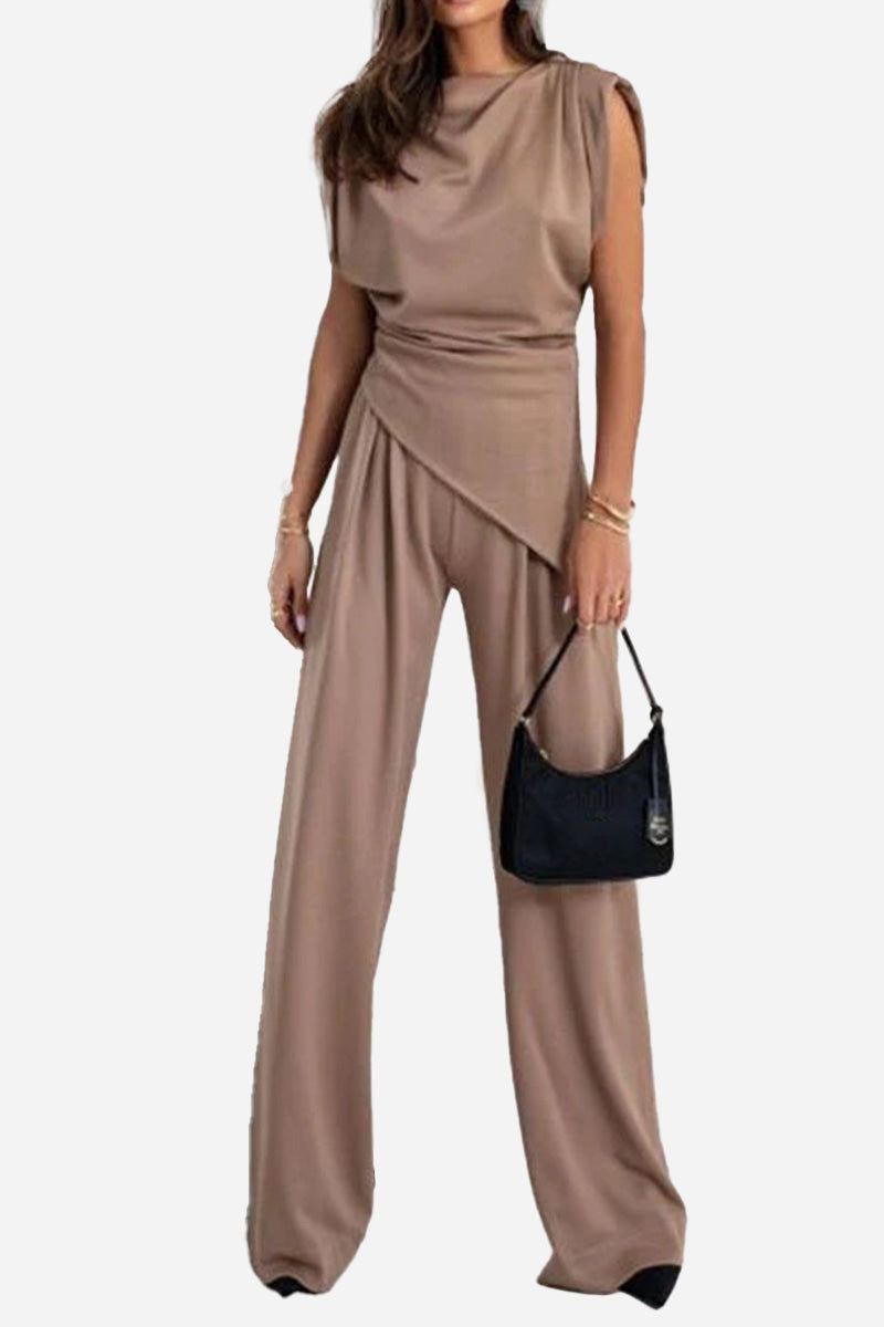 Woman wearing Manhattan Lines Draped two-piece set with asymmetrical draped top and wide-leg pants in taupe color.