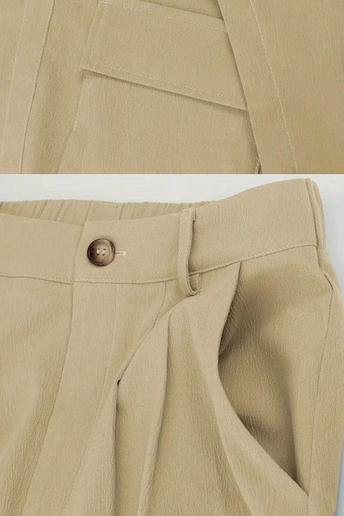 Close-up of beige two-piece set pants featuring large functional pockets and a button closure with elastic waistband.