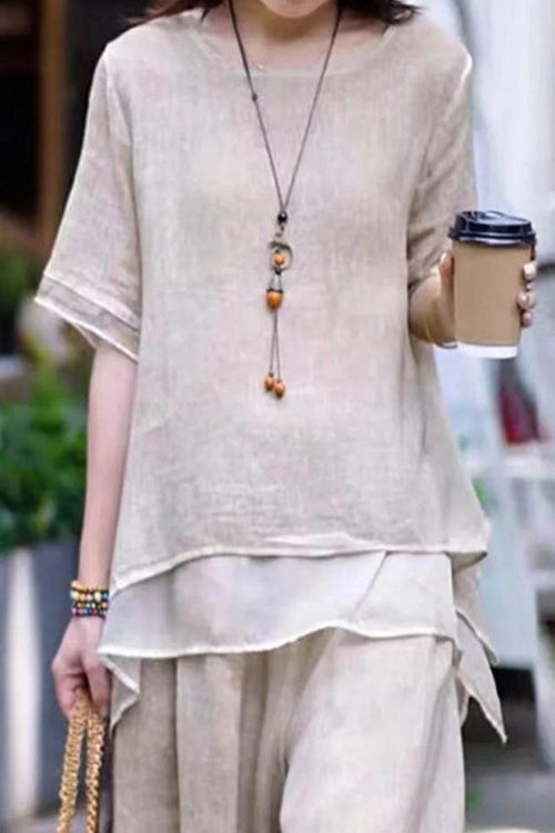 Woman wearing a soft beige Provence cotton linen blend layered top and wide-leg pants set, holding a coffee cup.