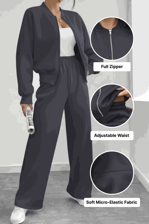 The Voyager Zip Set in black with full zipper jacket and adjustable waist wide-leg joggers in soft micro-elastic fabric, styled with white sneakers.