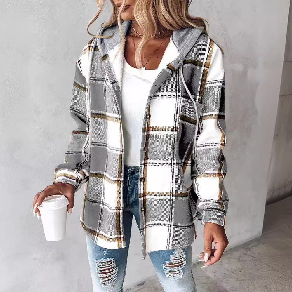 Highland Plaid Shacket with soft fleece lining, hood, button-front, front pockets, and relaxed fit in grey and white plaid pattern.