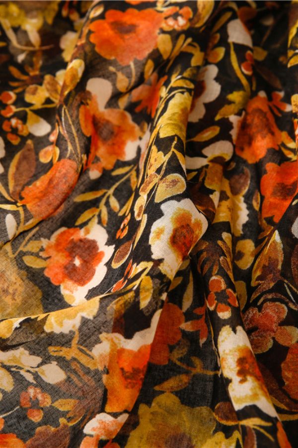 Twilight Blooms Scarf with warm amber, rust, and cream floral print on lightweight polyester fabric