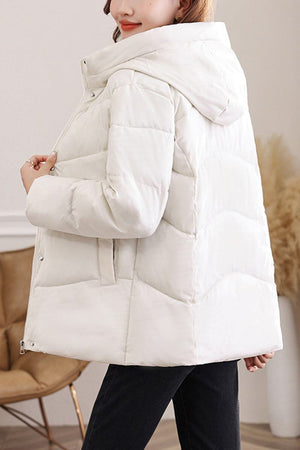 Lightweight mid-length Everyday Warmth Coat with 5-layer insulation, hood, and relaxed fit in white.