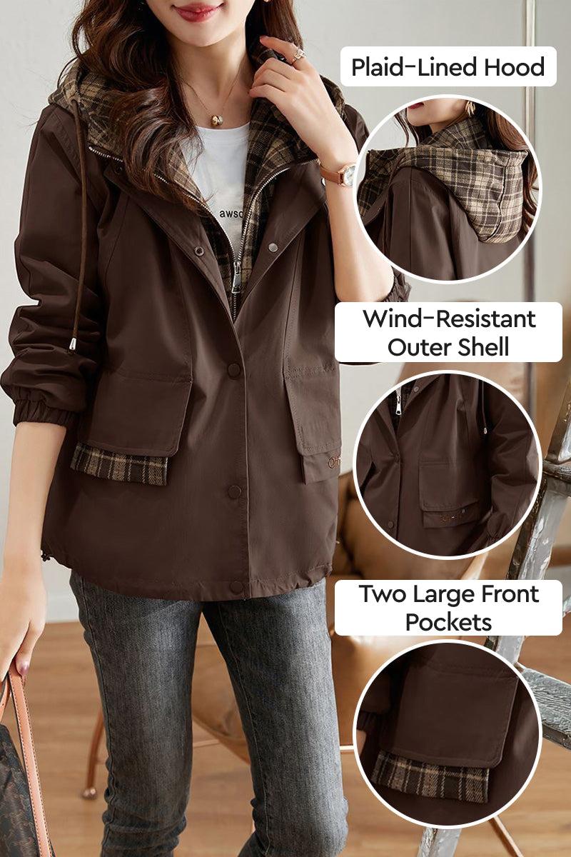 Woman wearing brown City Explorer Plaid Windbreaker with plaid-lined hood, wind-resistant shell, and two large front pockets.