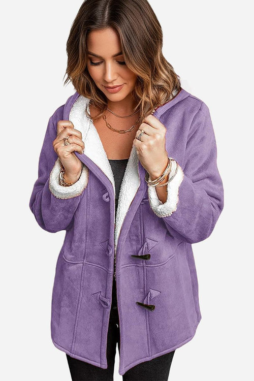 Woman wearing purple warm toggle button hooded coat with sherpa lining and faux suede exterior