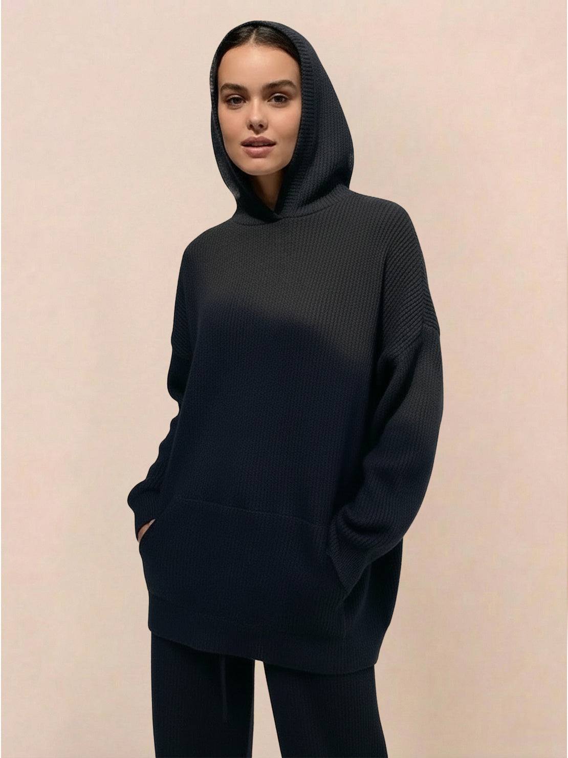 woman wearing black waffle-knit two-piece hoodie and pants lounge set