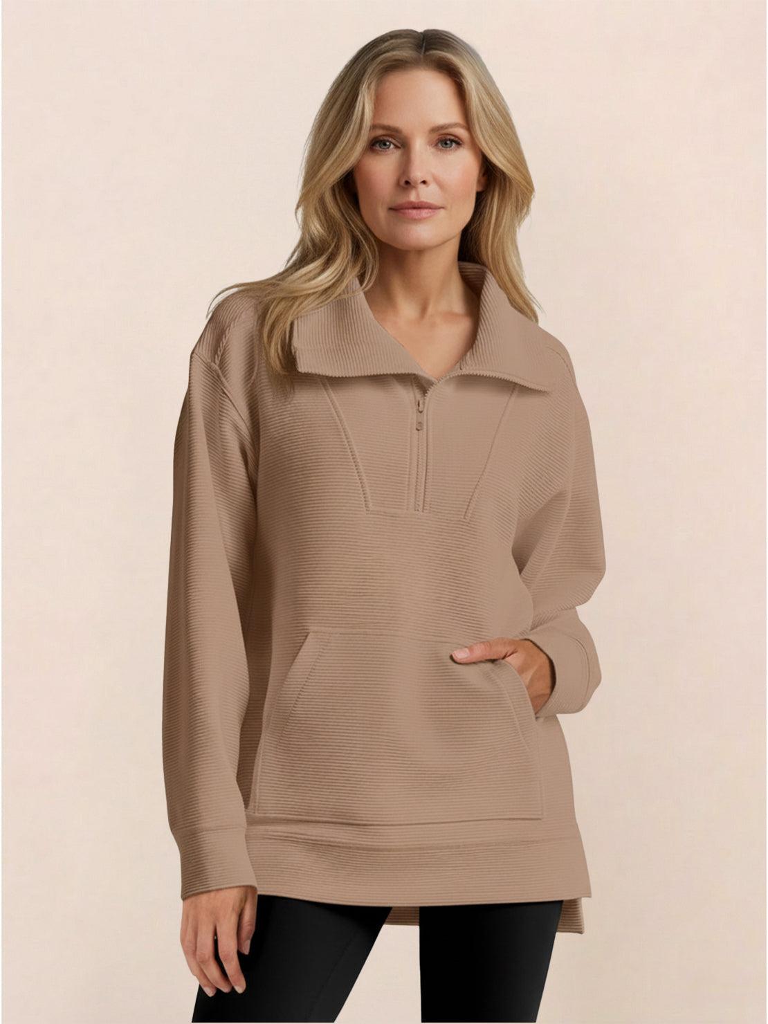 Half-zip waffle pullover with folded collar, kangaroo pocket, and relaxed fit in neutral tone.