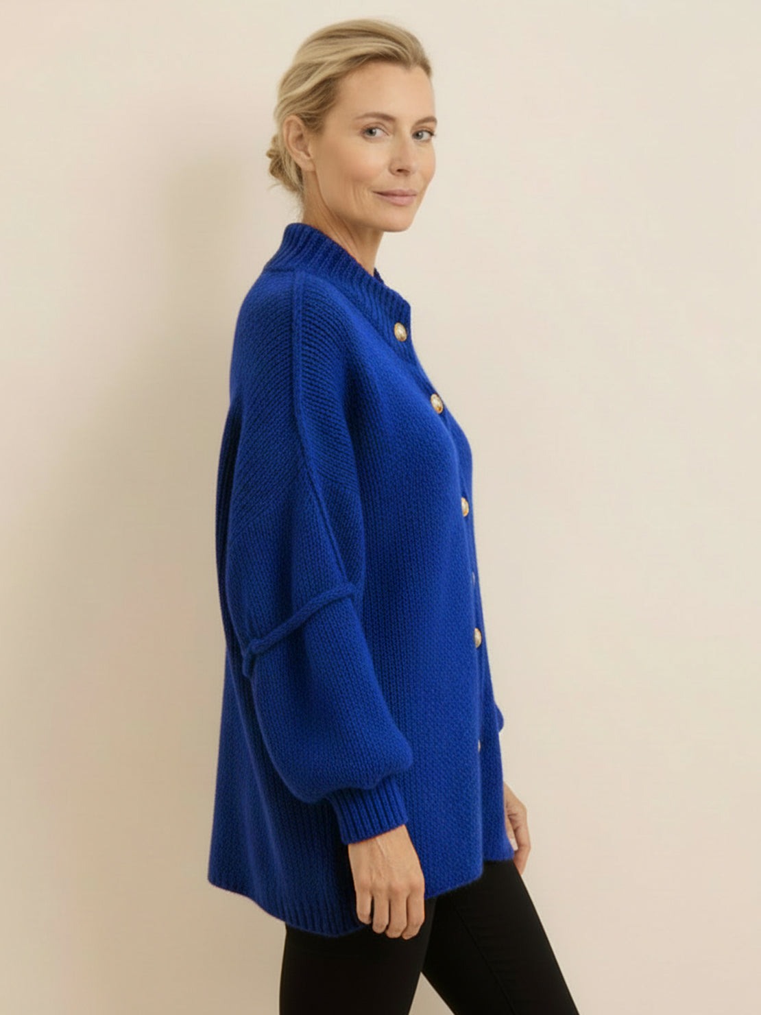 Oversized button-front knit cardigan with balloon sleeves, gold buttons, and chunky knit texture