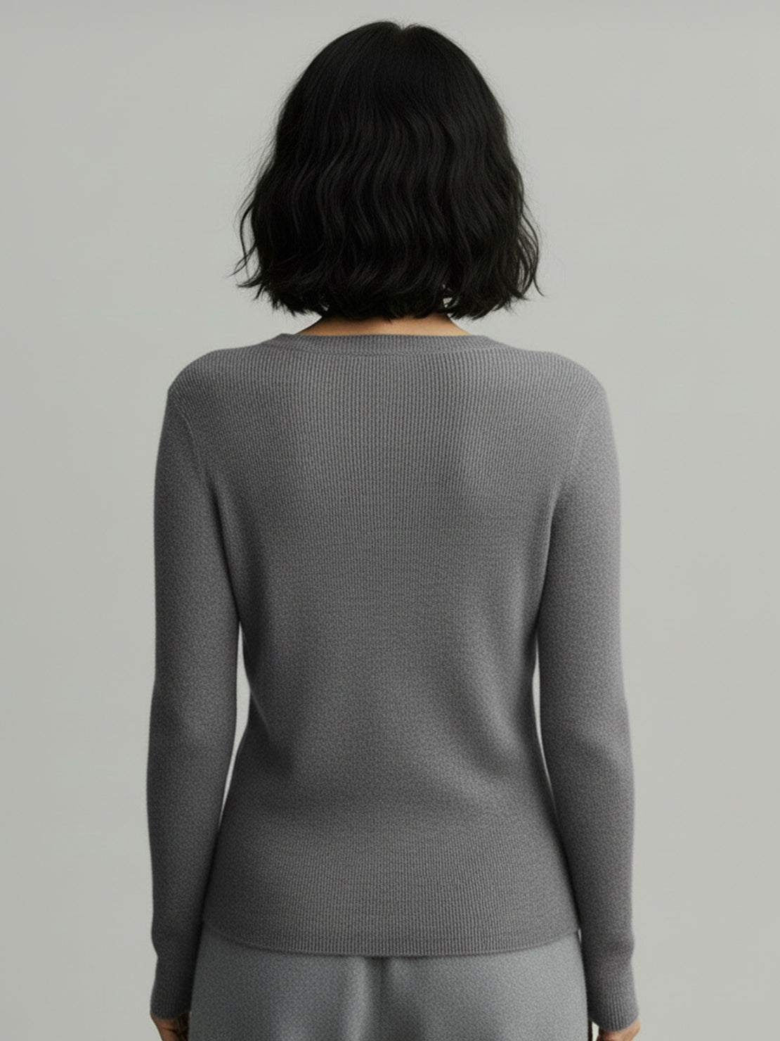 Lightweight 100% cashmere round neck pullover sweater with long sleeves and hip-length cut.