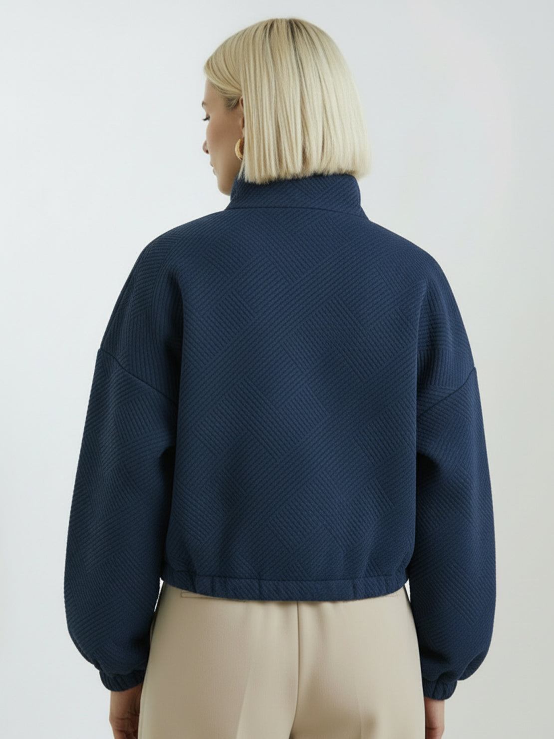 Cropped textured baseball jacket with full zipper, elastic cuffs, and waistband, perfect for casual layering.