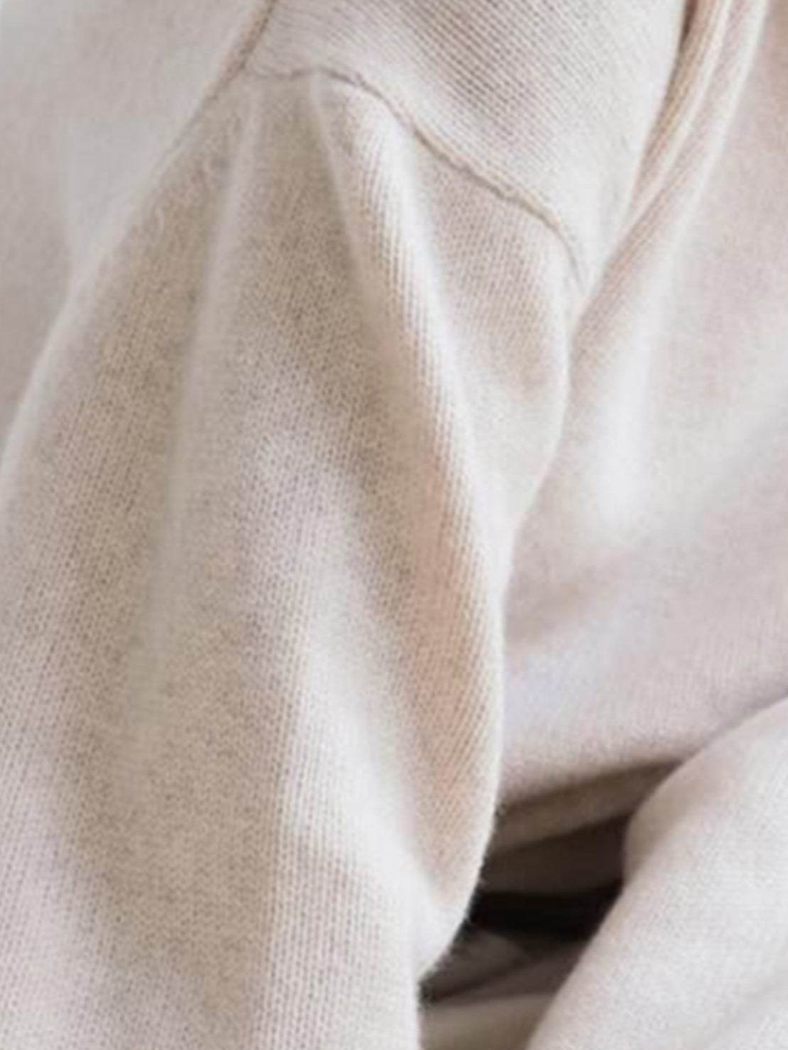 Oversized crew neck knit sweater with drop-shoulder sleeves and ribbed cuffs in neutral color