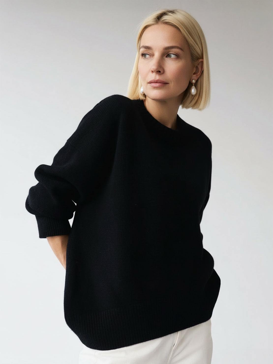 Oversized crew neck knit sweater with drop-shoulder sleeves and ribbed cuffs in neutral color