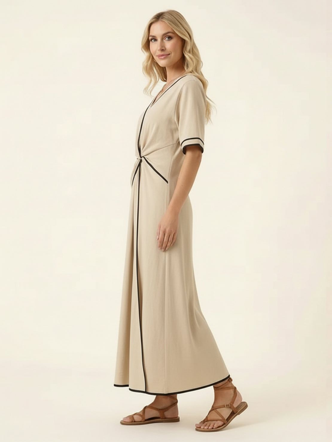 Woman wearing a knot-waist maxi dress with V-neckline and flowing skirt
