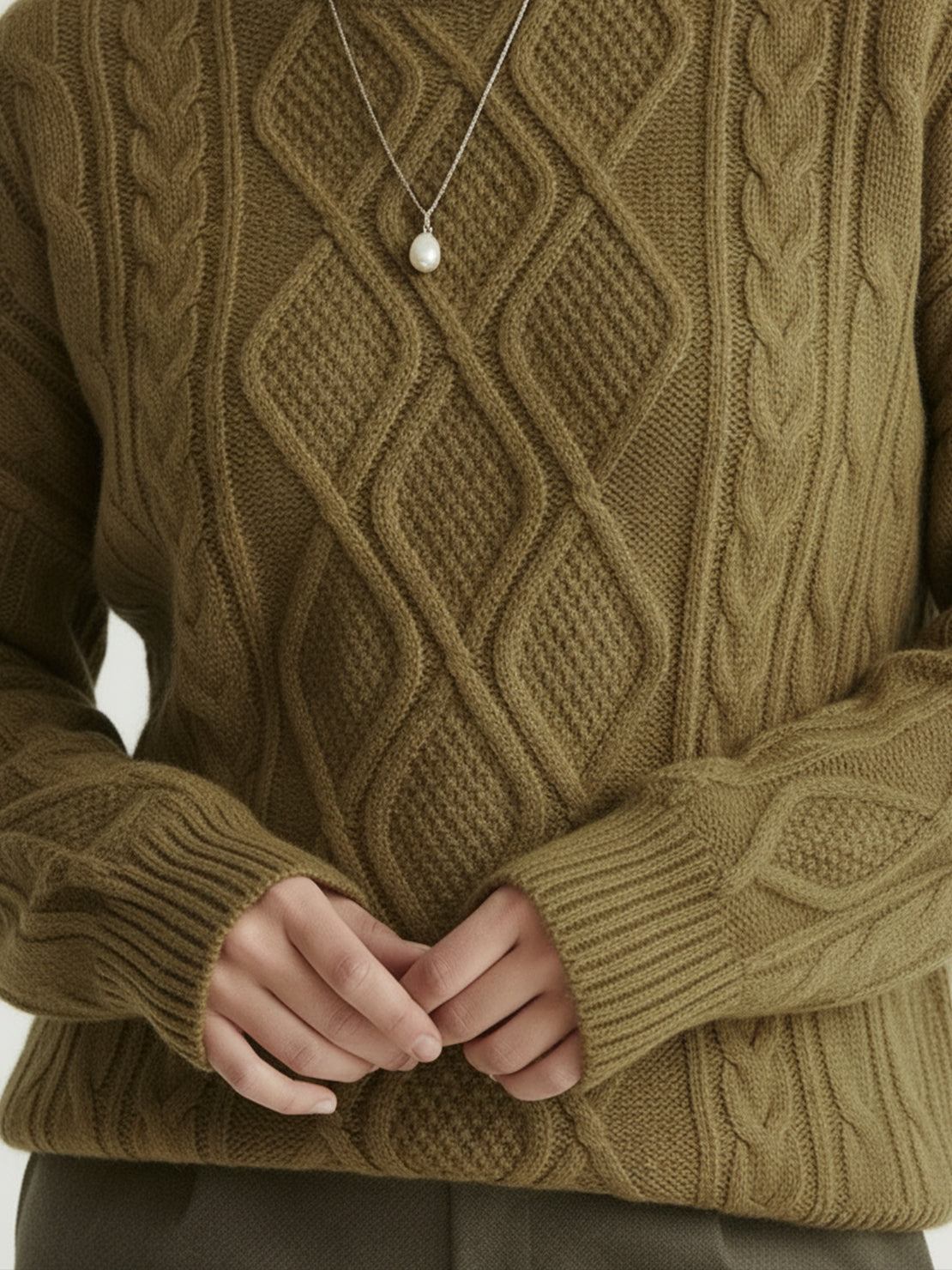 Oversized cable-knit crewneck sweater with dropped shoulders and ribbed trim