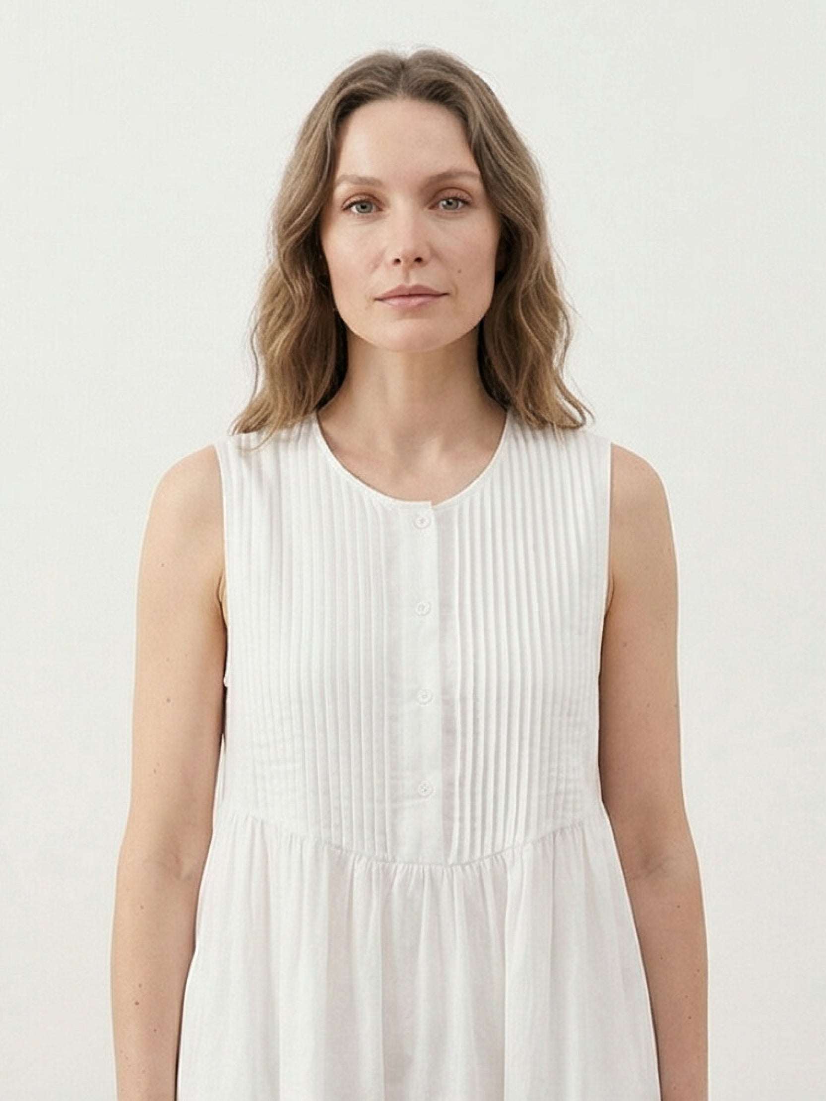 Sleeveless cotton linen pleated midi dress with pintuck bodice and calf-length A-line skirt