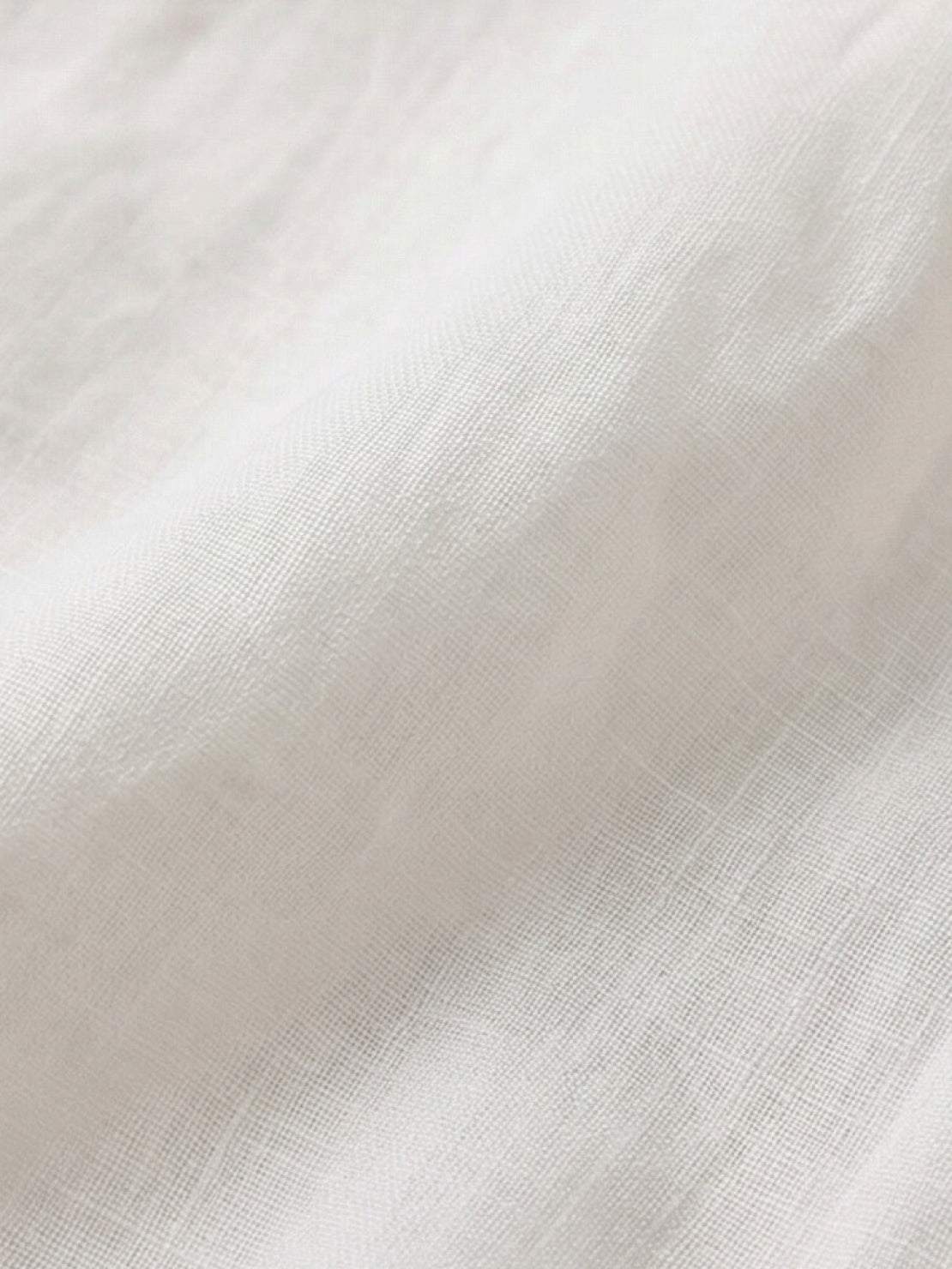 100% linen sheer overshirt with relaxed fit, semi-transparent fabric, classic collar, and button front