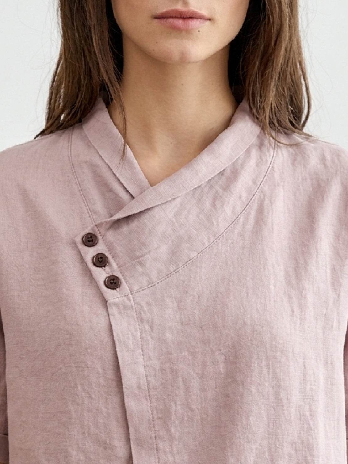 100% linen relaxed V-neck top with asymmetric button detail and short sleeves in cream color