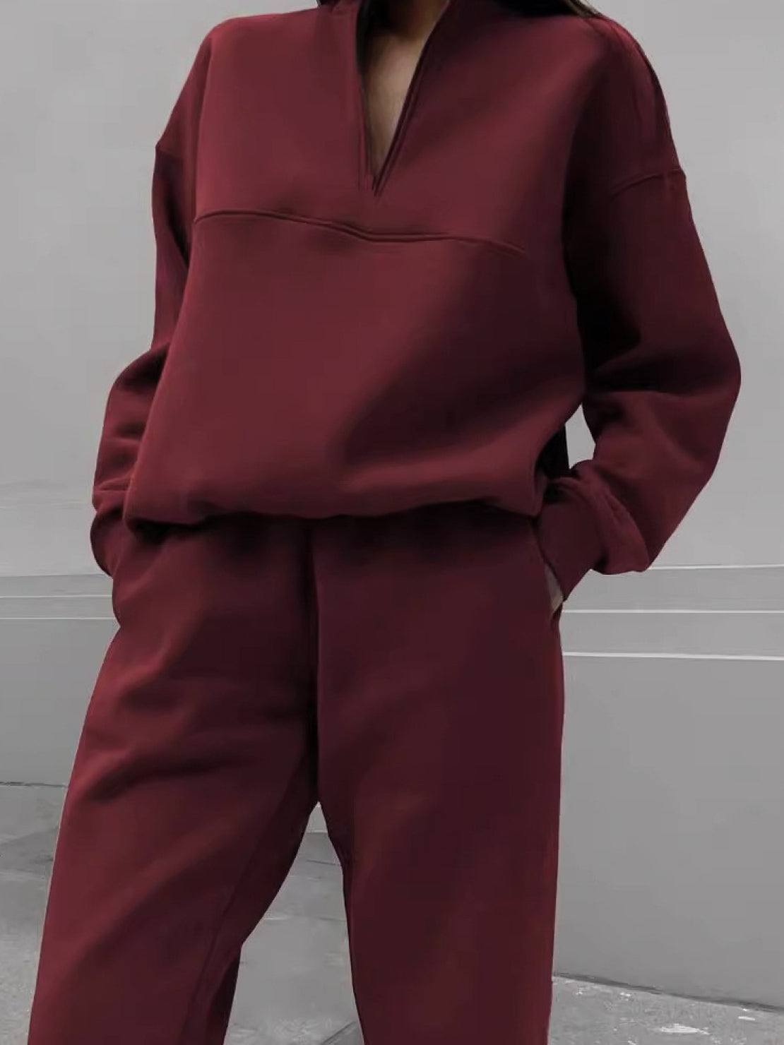 Woman wearing a cotton-blended two-piece tracksuit with high collar and zipper in a casual athleisure style