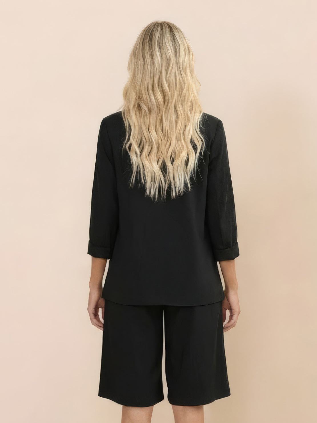 Woman wearing a polished blazer and high-waisted shorts two-piece set in a monochrome style