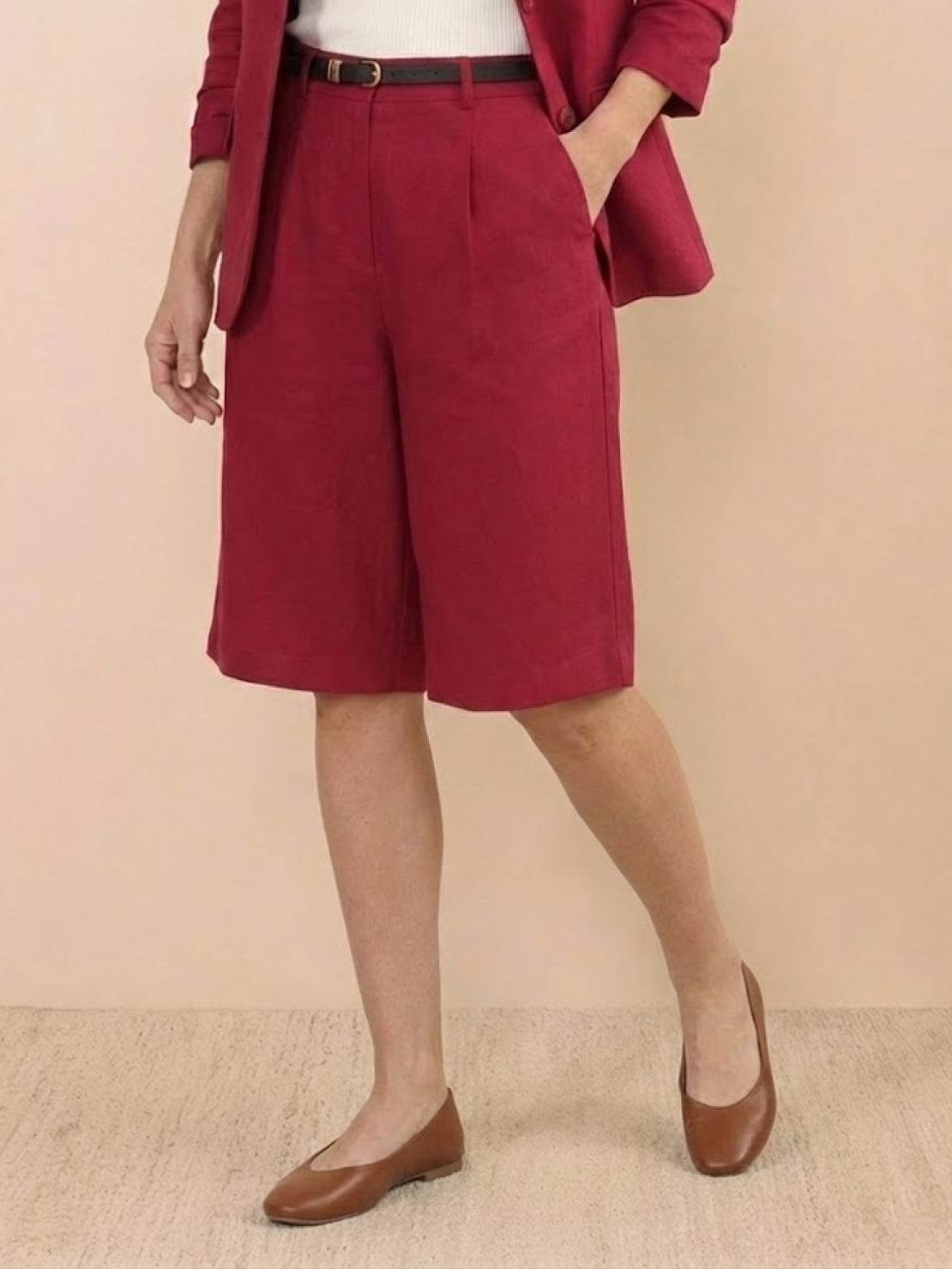 Woman modeling a polished blazer and high-waisted shorts two-piece set in a monochrome color with tailored fit and rolled-up sleeves.