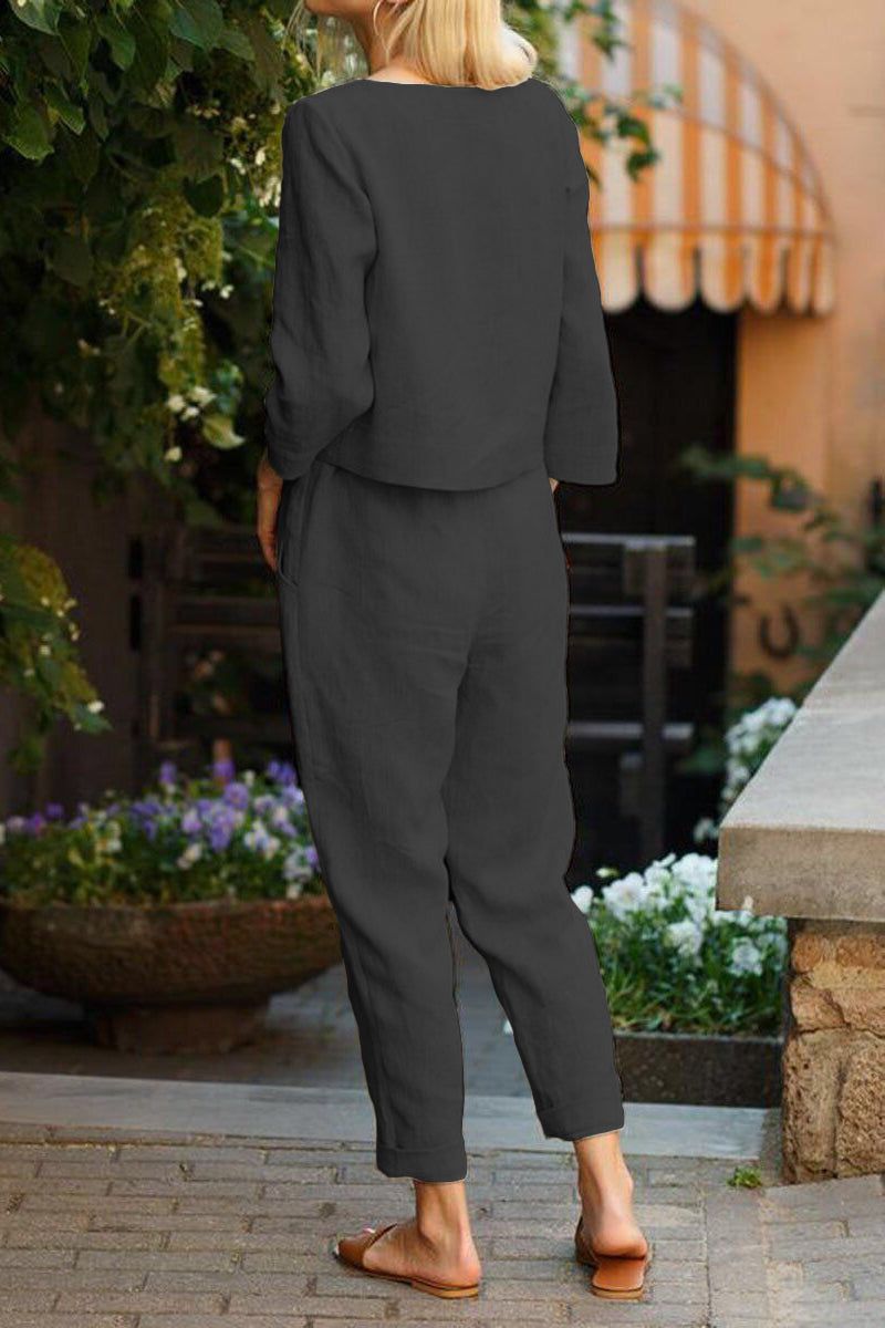 Back view of model wearing relaxed fit Cotton-Linen Monochrome Capsule longline top and wide-leg pants in dark monochrome outdoor setting