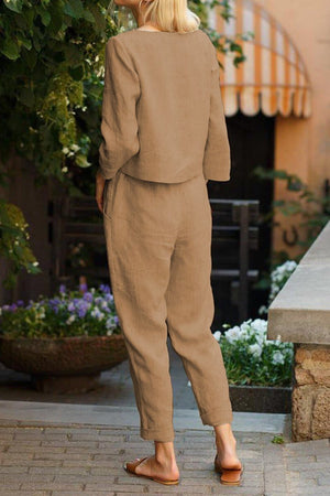 Women wearing cotton-linen monochrome capsule set with relaxed longline top and wide-leg pants in beige outdoors