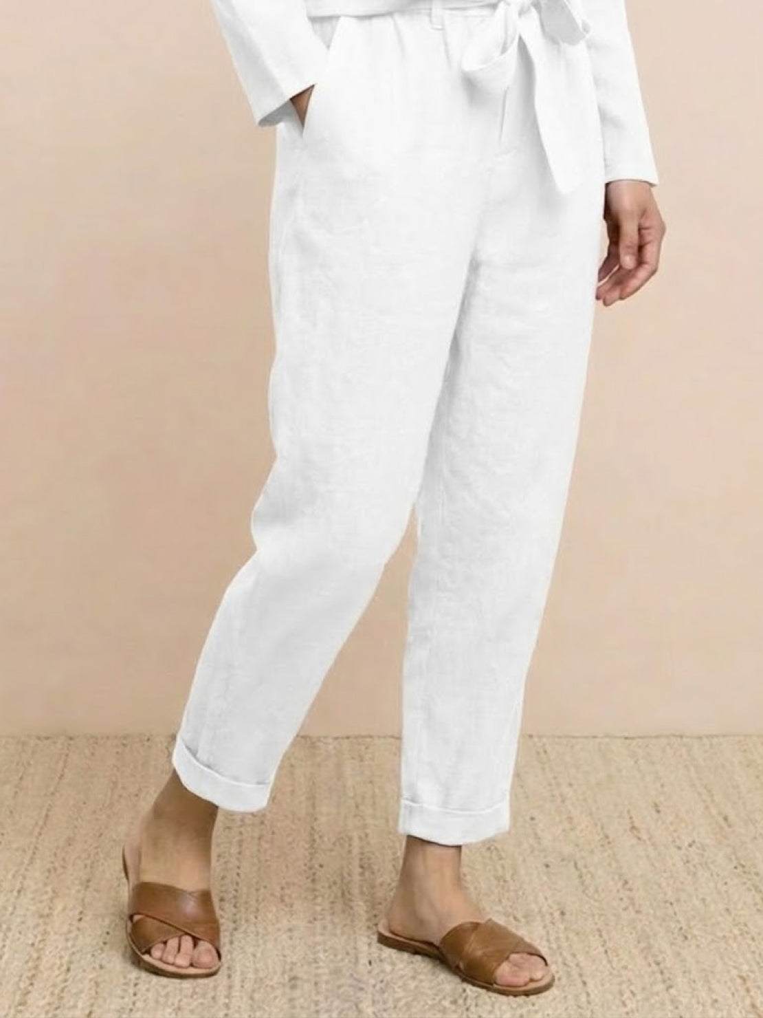 Woman wearing a relaxed cotton-linen monochrome capsule outfit with longline top and wide-leg pants