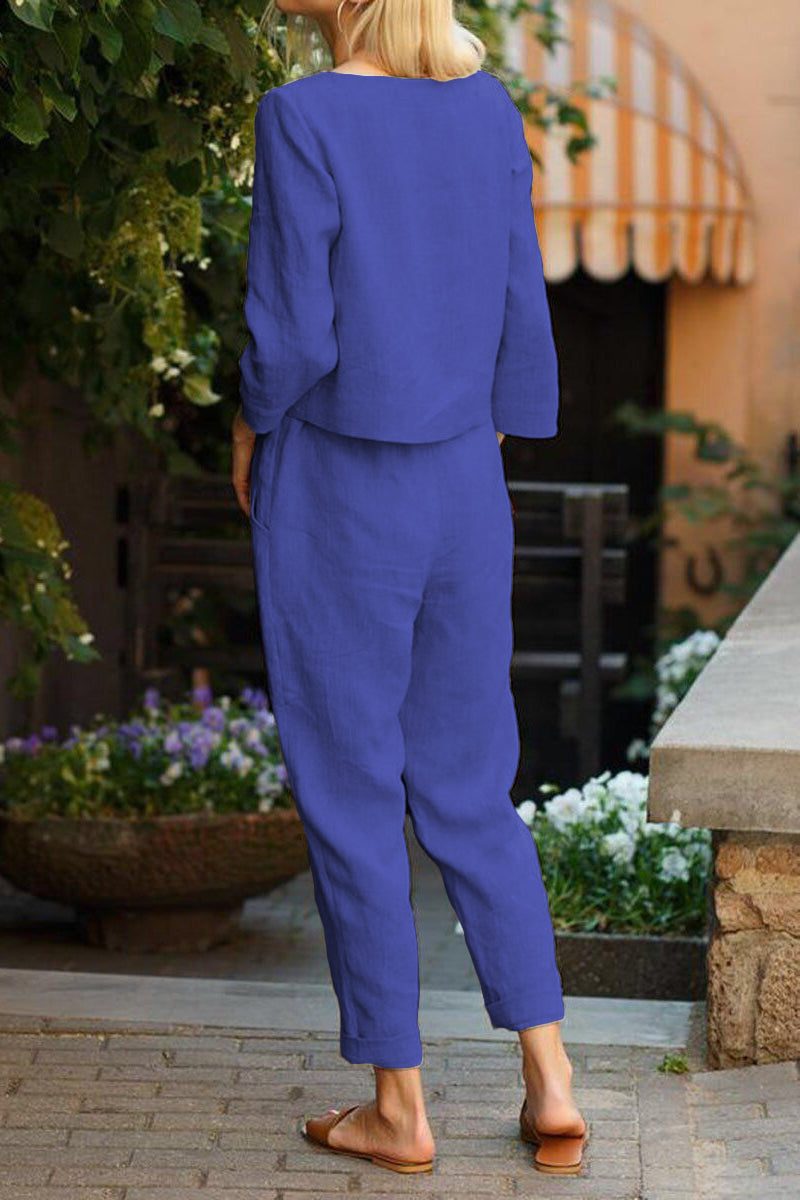 Woman wearing blue cotton-linen monochrome capsule outfit with longline top and wide-leg pants outdoors