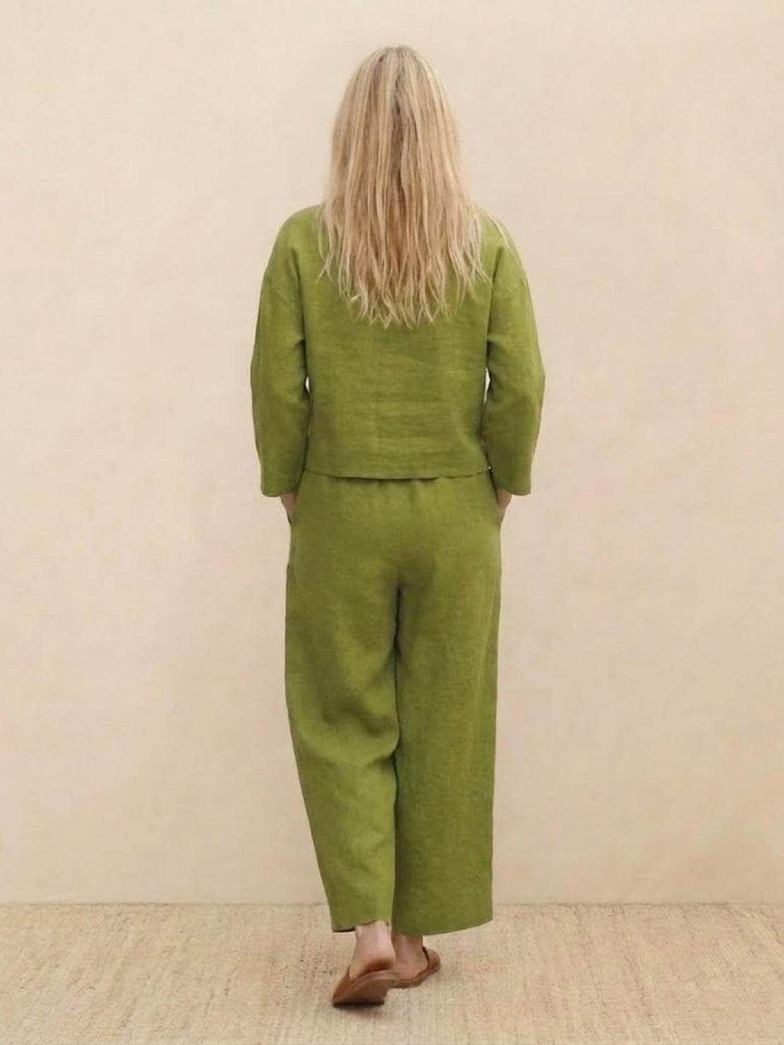 woman wearing loose solid color two-piece set with round neck top and wide-leg pants