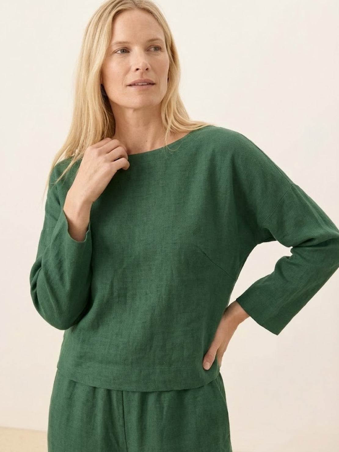 woman wearing loose solid color two-piece set with round-neck top and wide-leg pants