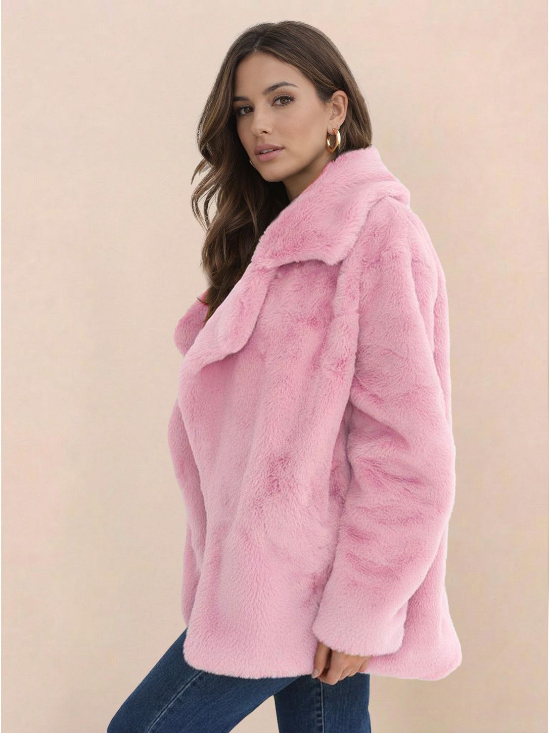 Woman wearing pink open front oversized faux fur jacket with draped collar and mid-hip length