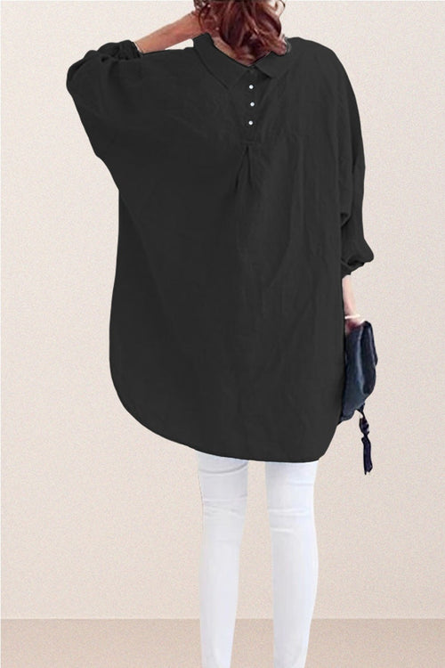 Oversized black linen shirt with back button details and relaxed fit on model